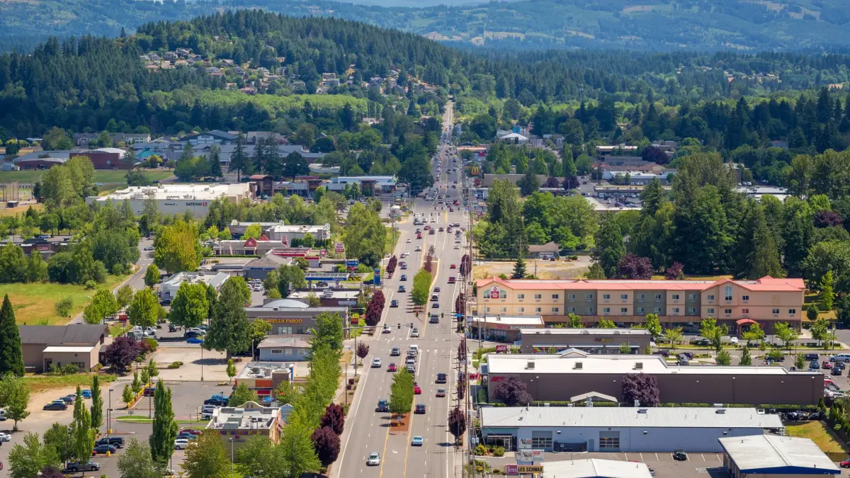 Main street in Battle Ground, WA, with forested hills beyond